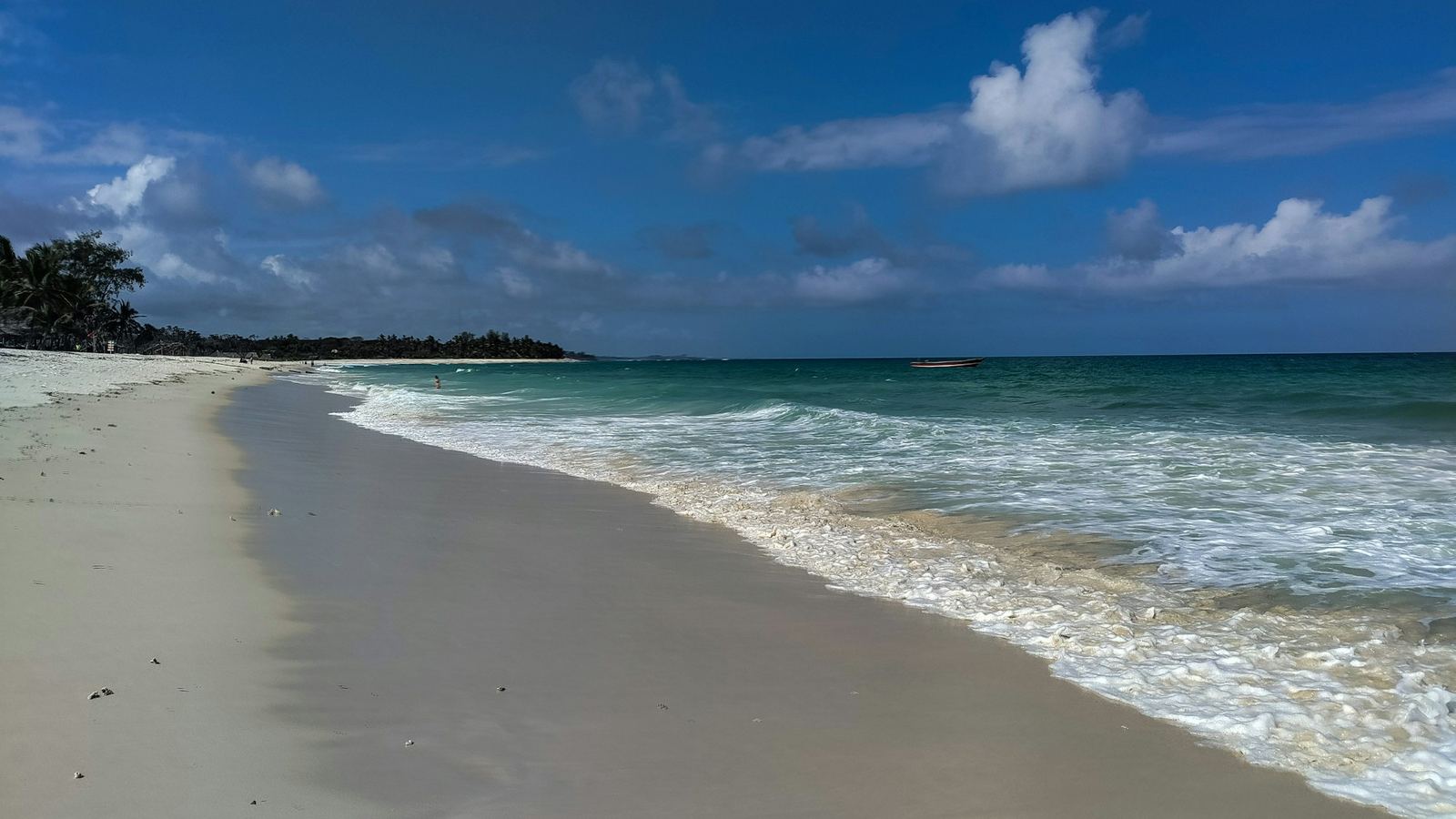 Long white-sand beach and turquoise sea at Diani on the south coast of Kenya