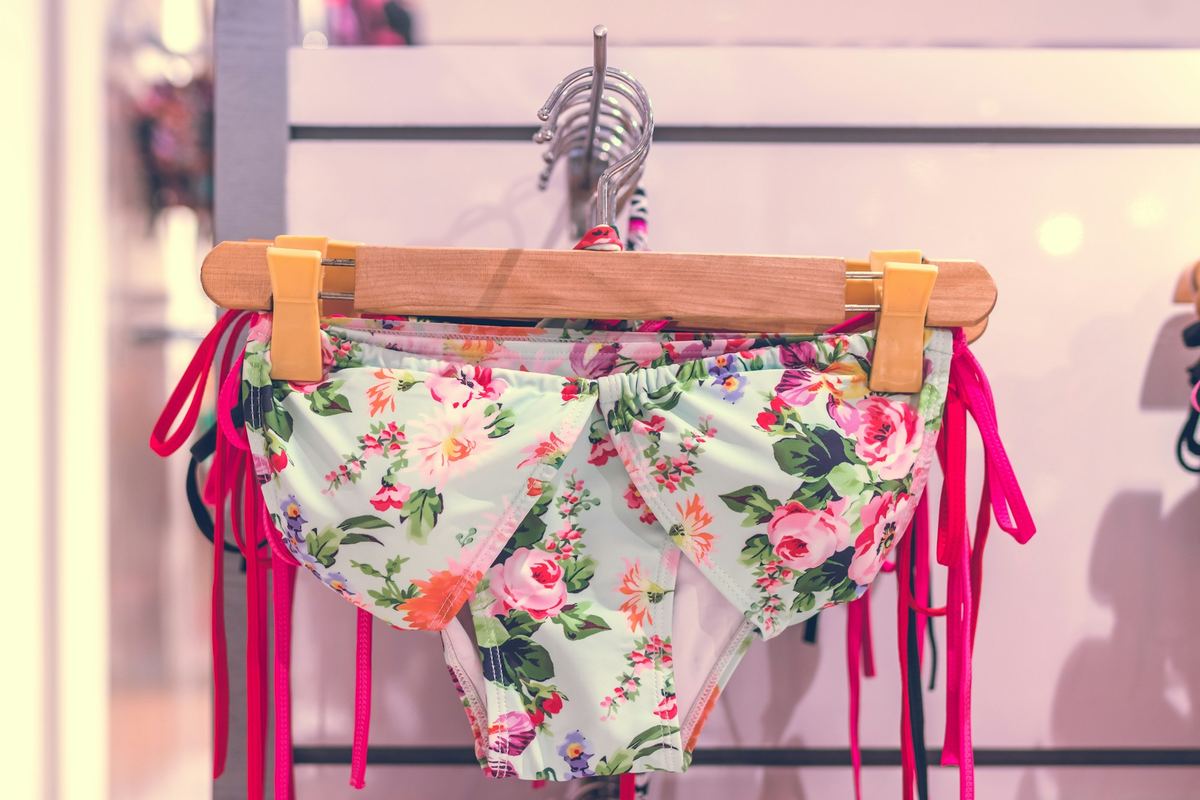 Floral bikini hanging on a wooden hanger