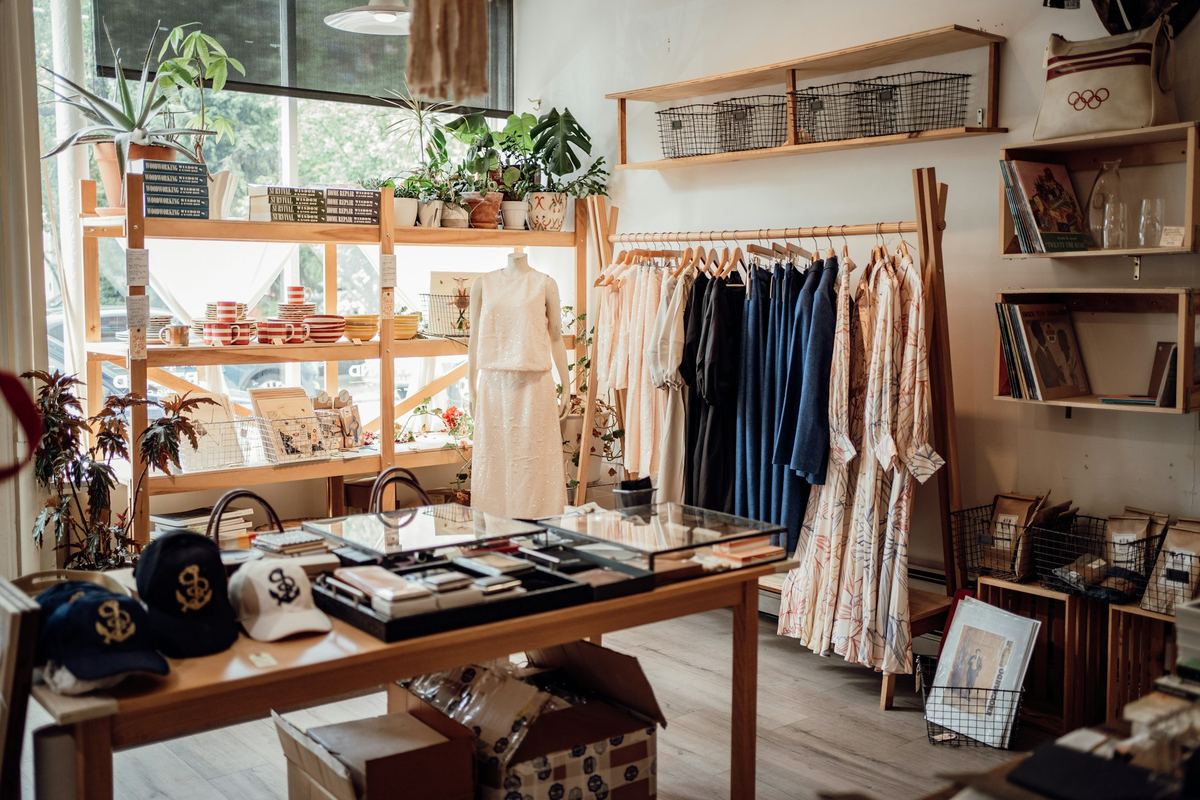 A boutique clothing rail with rows of hangers